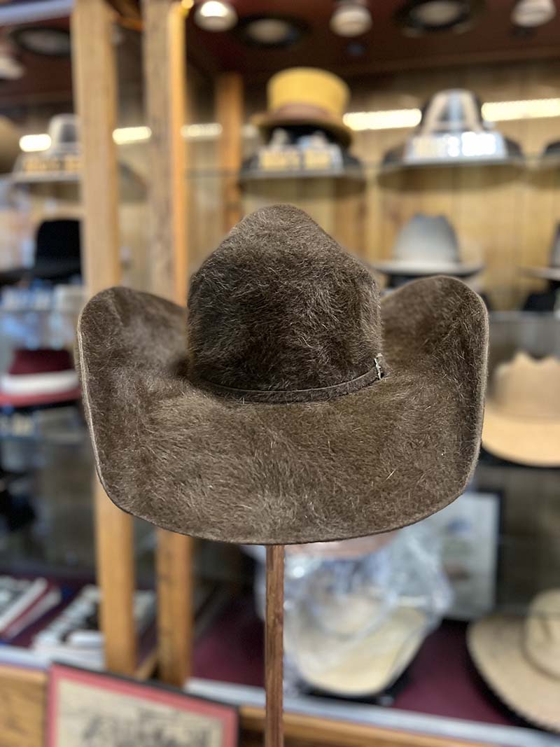 A brown textured cowboy hat photographed inside Mike’s Custom Hatters in Longview