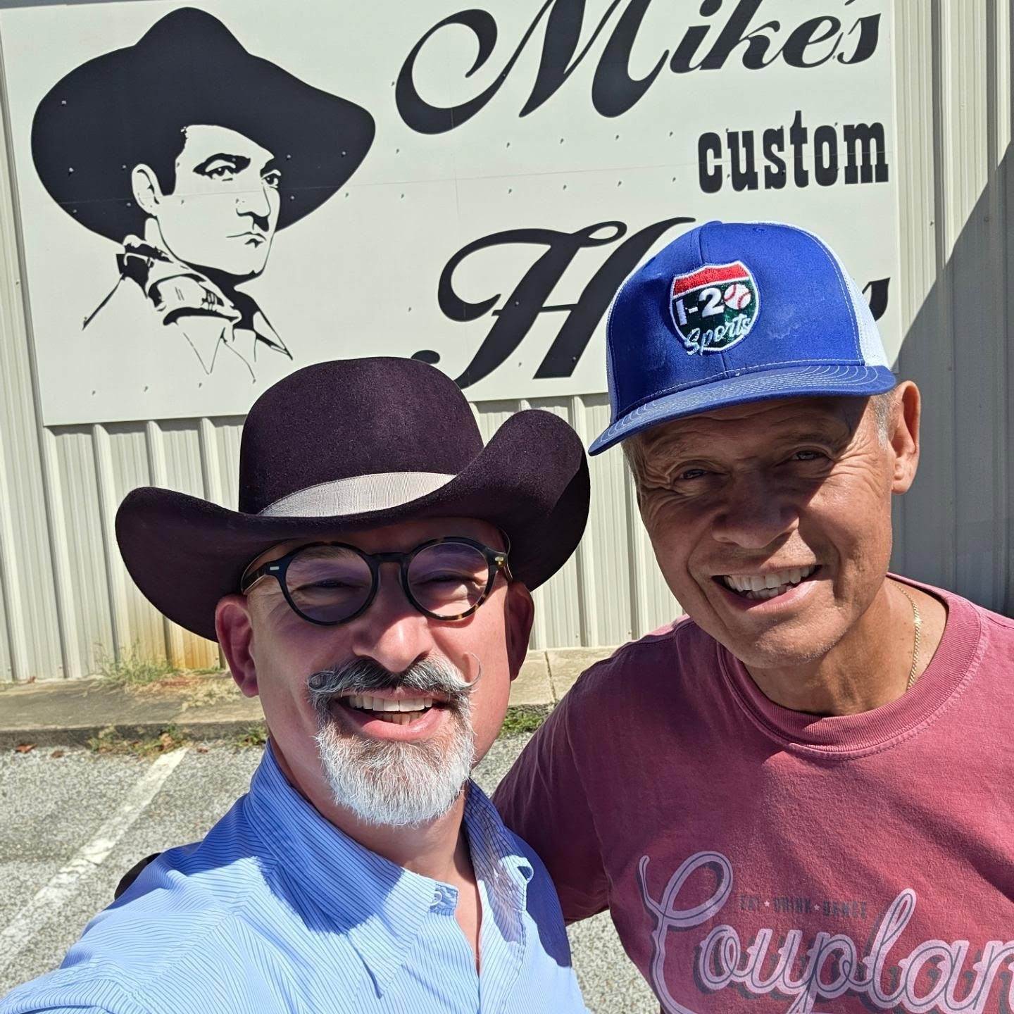 Neal McCoy photographed with another person outside Mike’s Custom Hatters