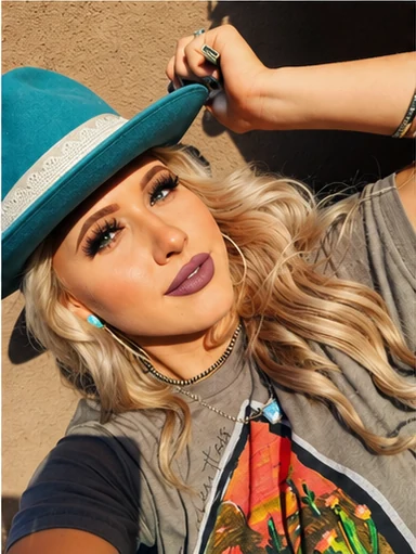 A woman wearing a turquoise broad-brimmed hat with a pale patterned band
